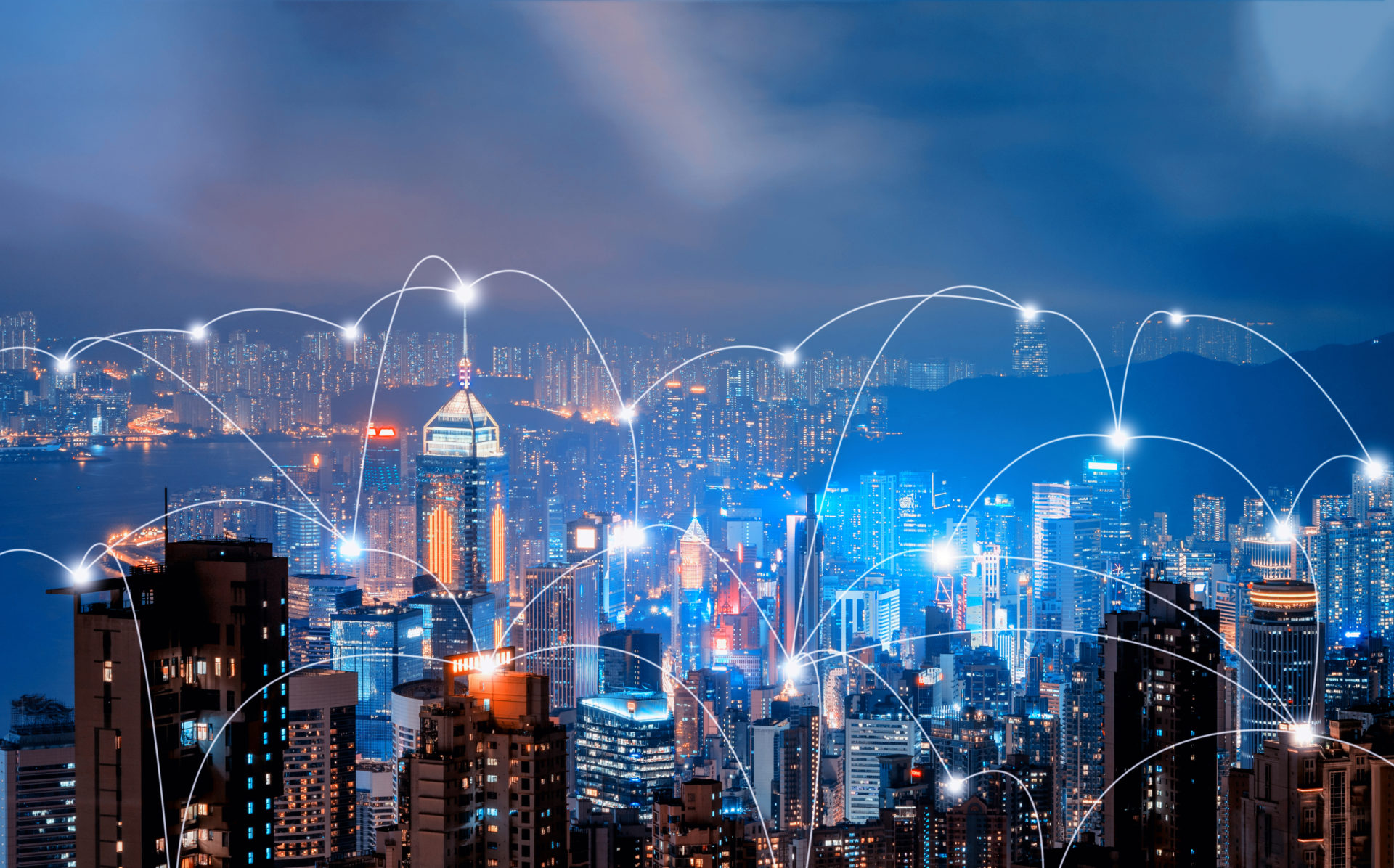 Digital network connection lines of Hong Kong Downtown and Victoria Harbour. Financial district in smart city in technology concept. Skyscraper and high-rise buildings. Aerial view at night.